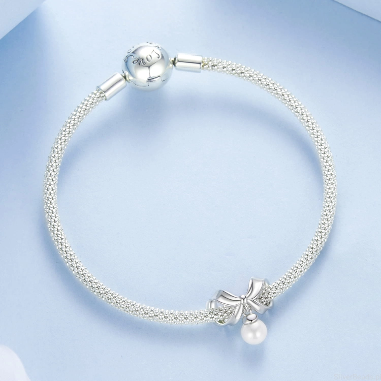 srebrny charms próba 925  kokarda z perełką