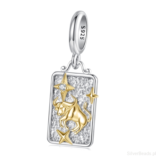 Srebrny charms byk ze złotym symbolem zodiaku.